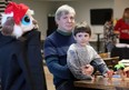 Jeff Gaspar sits with his grandson, Alec , 4, during the Windsor Essex County Grands Raising Kids Christmas party at The Gathering Saturday evening.