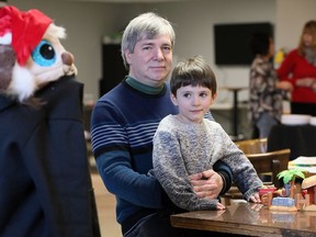 Jeff Gaspar sits with his grandson, Alec , 4, during the Windsor Essex County Grands Raising Kids Christmas party at The Gathering Saturday evening.