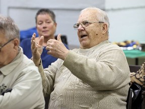 Parishioner Claude Marchand, 76, right, feels strongly Assumption Church should be saved.  In photo, Marchand asks a question of Paul Mullins, author of the second report on the church's future.