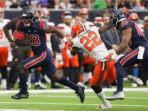 HOUSTON, TX - DECEMBER 02:  Alfred Blue #28 of the Houston Texans rushes past Jabrill Peppers #22 of the Cleveland Browns for a touchdown  that was called back for a holding penalty on Julie'n Davenport #70 at NRG Stadium on December 2, 2018 in Houston, Texas.