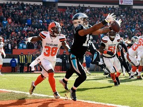 D.J. Moore #12 of the Carolina Panthers can't make a catch in front of T.J. Carrie #38 of the Cleveland Browns during the first quarter at FirstEnergy Stadium on December 9, 2018 in Cleveland, Ohio.