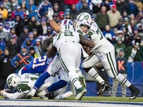 Matt Milano #58 of the Buffalo Bills reacts to injuring his left leg as Sam Darnold #14 of the New York Jets carries the ball to the 1 yard line during the fourth quarter at New Era Field on December 9, 2018 in Orchard Park, New York. New York defeats Buffalo 27-23.