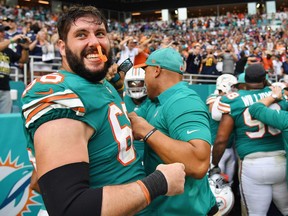 Travis Swanson #66 of the Miami Dolphins celebrates after defeating the New England Patriots 34-33 at Hard Rock Stadium on December 9, 2018 in Miami, Florida.