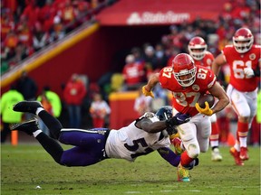 KANSAS CITY, MISSOURI - DECEMBER 09:  Tight end Travis Kelce #87 of the Kansas City Chiefs carries the ball after making a catch as inside linebacker C.J. Mosley #57 of the Baltimore Ravens defends during the game at Arrowhead Stadium on December 09, 2018 in Kansas City, Missouri.