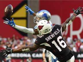 In this Dec. 9, 2018, file photo, Darius Slay #23 of the Detroit Lions catches the ball intended for Trent Sherfield #16 of the Arizona Cardinals before running the ball 67 yards for a touchdown in the second half of NFL game in Glendale, Arizona.