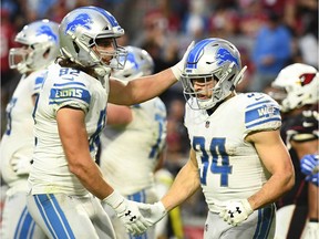 Zach Zenner #34 of the Detroit Lions is congratulated by LaSalle native Luke Willson #82 after scoring a one yard touchdown against the Arizona Cardinals in the fourth quarter of the NFL game at State Farm Stadium on December 09, 2018 in Glendale, Arizona. The Detroit Lions won 17-3.