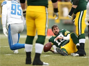 QB Aaron Rodgers of the Green Bay Packers lays on the ground after being sacked by Romeo Okwara of the Detroit Lions during the first half of a game at Lambeau Field on December 30, 2018 in Green Bay, Wisc.
