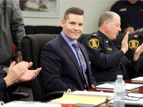 Bryce Chandler, centre, is introduced to the Windsor Police Services Board Wednesday December 12, 2018.
Chandler will be the director of human resources and legal counsel. Windsor Police Deputy Chief Brad Hill, left, applauds with other officers, right.
