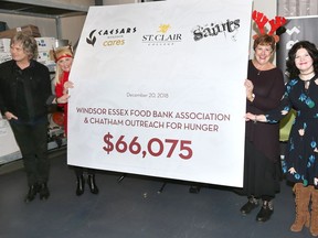 The 2018 Sleighing Hunger Charity Concert raised $66,075 for Windsor Essex County Food Bank Assoc. (WEFBA) and Chatham Outreach for Hunger.  In photo, The S'Aints drummer Jeff Burroughs, left, June Muir, president of WEFBA, Kim Scoyne of Chatham Outreach for Hunger and St. Clair College President Patti France, right, pose with the generous donation Thursday.  The donation will be shared amongst 16 foodbanks in the region. The S'Aints Sleighing Hunger holiday show goes Friday Dec. 21st at The Colosseum at Caesars Windsor.