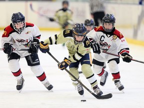 In this Dec. 27, 2018, file photo, LaSalle's Steven Toniolo, centre, breaks away from Tecumseh's R.J. Koppeser, left, and Marshall Dowie, right, in atom division action at Lakeshore's Atlas Tube Centre during the 23rd annual Hockey for Hospice tournament.