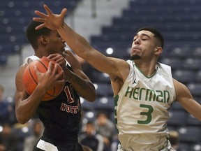 Jaden Ogorek, left, of the Sarnia Northern Vikings and Nate Carson, of the Herman Green Griffins, battle for the ball on Friday at the 62nd University of Windsor Invitational High School Basketball Tournament.

, December 14, 2018, at the St. Denis Centre in Windsor during the 62nd annual Invitational High School tournament.