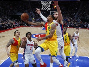 Milwaukee Bucks guard George Hill (3) drives against Detroit Pistons forward Blake Griffin in the second half of an NBA basketball game in Detroit, Monday, Dec. 17, 2018.