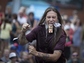 Sweet Pepper from the Monsters of Schlock has his tongue trapped in a mouse trap as he performs at the Walkerville Buskerville Festival, Saturday, August 11, 2018.