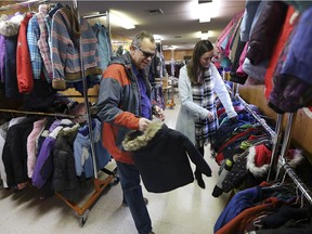 Warm all over. The Unemployed Help Centre's Coats for Kids program received over 300 coats on Dec. 13, 2018, from the annual coat drive by Windsor's Muslim community. Here, Russ Anderson, chairman of the organization and Heidi Benson, coordinator, hang up donated coats.