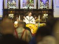 The reverend Robert Clifford performs the Holy Eucharist at All Saints' Anglican Church on Christmas Morning in downtown Windsor, Tuesday, December 25, 2018.