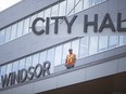 Finishing touches are made as workers install large 'Windsor City Hall' sign on to the new City Hall building in downtown Windsor, Thursday, July 19, 2018.