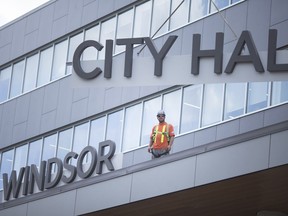 Finishing touches are made as workers install large 'Windsor City Hall' sign on to the new City Hall building in downtown Windsor, Thursday, July 19, 2018.