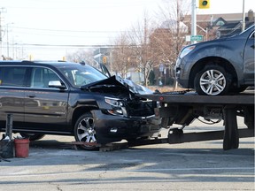 Two vehicles involved in an accident at the corner of Ouellette Avenue and Giles Boulevard are removed from the scene Saturday, December 16, 2018. Windsor police said no one was injured in the crash.
