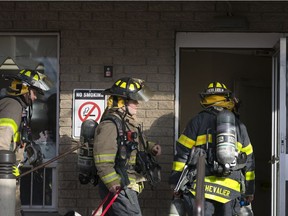 Fire crews work at the scene of an apartment fire at 920 Ouellette Ave., Wednesday, Dec. 19, 2018.  One woman was taken to hospital with unknown injuries.