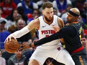 Atlanta Hawks forward Vince Carter, right, tries to steal the ball from Detroit Pistons forward Blake Griffin, left,during the second half of an NBA basketball game Sunday, Dec. 23, 2018, in Detroit.