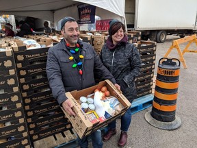 Mike and Deanna Diab show off a box full of Christmas dinner essentials, including a frozen turkey, in Leamington Saturday, December 15, 2018. This is the couple's third year organizing Talking Over Turkey, an event to give away free turkeys and other food to anyone who wants it.