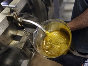 In this April 24, 2018, file photo, the first rendering from hemp plants extracted from a super critical CO2 extraction device on it's way to becoming fully refined CBD oil spurts into a large beaker at New Earth Biosciences in Salem, Ore. The hemp industry still has work ahead to win legal status for hemp-derived cannabidiol, or CBD oil. The head of the Food and Drug Administration says adding CBD to food or dietary supplements is still illegal. President Donald Trump signed a farm bill this week designating hemp as an agricultural crop, but FDA Commissioner Scott Gottlieb issued a statement saying CBD is a drug ingredient and therefore illegal to add to food or supplements without approval from his agency.