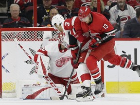 Detroit Red Wings' Nick Jensen (3) and goalie Jonathan Bernier defend the net in front of Carolina Hurricanes' Warren Foegele (13) during the first period of an NHL hockey game in Raleigh, N.C., Thursday, Dec. 20, 2018.