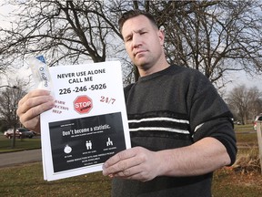Brandon Bailey, a member of the Windsor Overdose Prevention Society, is shown Dec. 13, 2018, at his Windsor home with a flyer he is circulating throughout the city. It encourages anyone considering using potentially dangerous drugs not to do so alone.