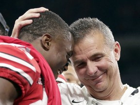 FILE - In this Dec. 2, 2018, file photo, Ohio State head coach Urban Meyer and wide receiver Terry McLaurin, left, celebrate early after defeating Northwestern 45-24 in the Big Ten championship NCAA college football game in Indianapolis.