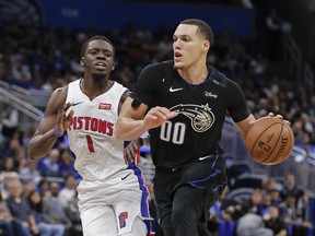 Orlando Magic's Aaron Gordon drives around Detroit Pistons' Reggie Jackson during the second half of an NBA basketball game, Sunday, Dec. 30, 2018, in Orlando, Fla.