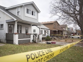 Police tape surrounds the front of a house at 1093 Windsor Ave., where a woman is being charged with attempted murder in a stabbing investigation on Dec. 24, 2018.