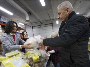 Local philanthropist Sam Sinjari handed out over 100 turkeys on Dec. 21, 2018, at the Unemployed Help Centre in Windsor. Sinjari purchased the turkeys and was joined by Windsor city council newcomers Kieran McKenzie, Gary Kaschak and Jim Morrison as well as Windsor West MPP Lisa Gretzky. Sinjari is shown here handing out a turkey to a client of the centre as MPP Lisa Gretzky looks on.