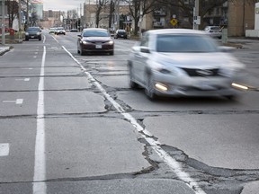 Vehicles travel over crumbling pavement on University Avenue West, near the University of Windsor, Monday, December 17, 2018.
