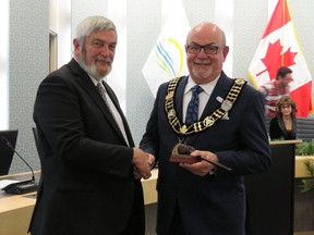New Essex County Warden Gary McNamara (right) shakes hands with his predecessor Tom Bain (left) after McNamara's election to the Warden position at Essex County Council on Dec. 12, 2018.