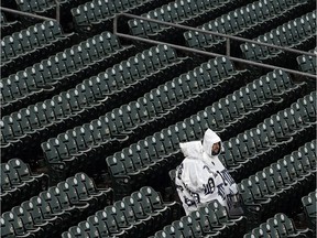 Fans sit in the stands at Comerica Park as rain delays the start of a baseball game between the Detroit Tigers and Toronto Blue Jays in Detroit onApril 10, 2013.