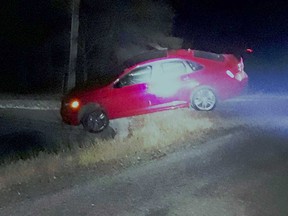 A car balances on the edge of a culvert on South Malden Road in Essex on the night of Dec. 14. OPP have charged the motorist with impaired driving.