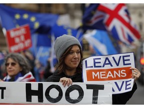 Demonstrators protest for Britain's Brexit split from Europe, outside the Houses of Parliament in London Thursday Dec. 6, 2018. Britain's Prime Minister Theresa May's effort to win support for her Brexit agreement comes amid reports in British newspapers Thursday, predicting that Parliament could reject the deal by more than 100 votes.