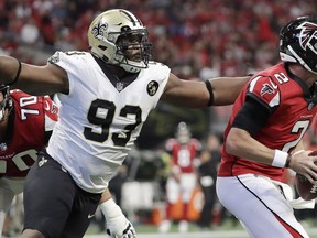 New Orleans Saints defensive tackle David Onyemata (93) grabs Atlanta Falcons quarterback Matt Ryan (2) during the first half of an NFL football game in Atlanta on September 23, 2018.