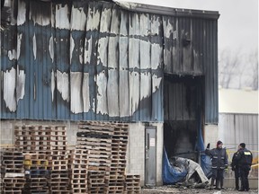 Fire investigators examine the aftermath of a 26-hour blaze at Global Pack Packaging Solutions on Road 3 East near Kingsville on Dec. 11, 2018.