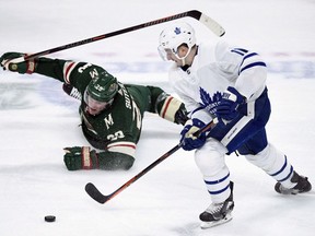 Minnesota Wild defenceman Ryan Suter (20) watches as Toronto Maple Leafs left wing Zach Hyman (11) takes the puck during the third period of an NHL hockey game Saturday, Dec. 1, 2018, in St. Paul, Minn. Hyman had a hearing with the NHL department of player safety on Sunday following his hit on Boston Bruins defenceman Charlie McAvoy.THE CANADIAN PRESS/AP /Hannah Foslien ORG XMIT: CPT111