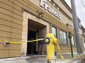 Police tap remains in front of Franco's after an over night fire.
