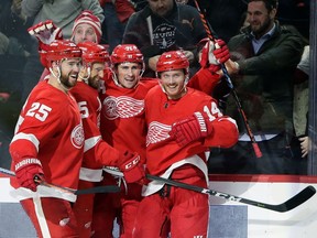 Detroit Red Wings center Dylan Larkin, second from right, celebrates with teammates Mike Green (25), Niklas Kronwall (55) and Gustav Nyquist (14) after scoring against the Los Angeles Kings during the second period of an NHL hockey game Monday, Dec. 10, 2018, in Detroit.