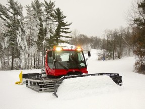 Boler Mountain's Marty Thody uses their groomer to flatten out piles of snow in preparation for their opening on Wednesday in London. They will have 5 runs ready for skiers said Thody. (Mike Hensen/The London Free Press)