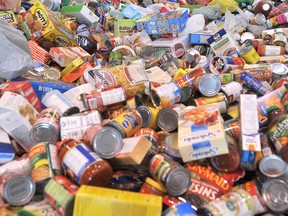 St. Christophers High School student Kayla Young, 15, sits in the middle of a massive pile of donated food during the school's annual Cyclone-Aid food drive on Saturday April 16, 2011, in Sarnia, Ontario. Over 260 students canvassed Point Edward, Bright's Grove and Sarnia's north end to gather the food for the Inn of the Good Shepherd food bank. Organizers are optimistic they were able to gather more than 30,000 lbs. of food from the event. SHAWN JEFFORDS/THE OBSERVER/ QMI AGENCY