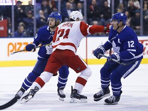 Toronto Maple Leafs William Nylander and teammate Patrick Marleau try to sandwich Detroit Red Wings Dylan Larkin during the first period in Toronto on Thursday, Dec. 6, 2018.