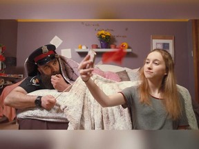 An image from a new Windsor police video about internet safety - featuring Officer Red Flag (Niko Lorkovich), who tries to warn a youthful female (Julia Pastorius) about the dangers of online interactions.