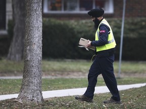 Crime Stoppers is offering rewards for information leading to porch pirates. These are the people who steal packages after they have been left by couriers. A Canada Post employee delivers a package to a home in east Windsor on Tuesday, Dec. 11, 2018.