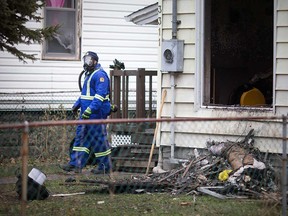 A Windsor fire investigator examines the aftermath of a house fire at 3311 Peter St. on Dec. 5, 2018.