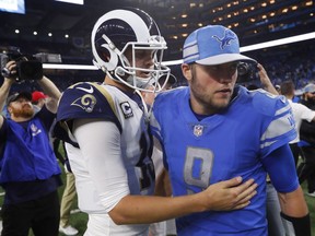 Los Angeles Rams quarterback Jared Goff, front left, meets with Detroit Lions quarterback Matthew Stafford after an NFL football game, Sunday, Dec. 2, 2018, in Detroit.