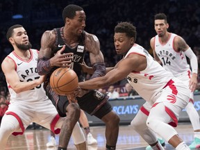 Toronto Raptors guard Kyle Lowry, front right, fouls Brooklyn Nets forward Rondae Hollis-Jefferson (24) during the second half of an NBA basketball game, Dec. 7, 2018, in New York.